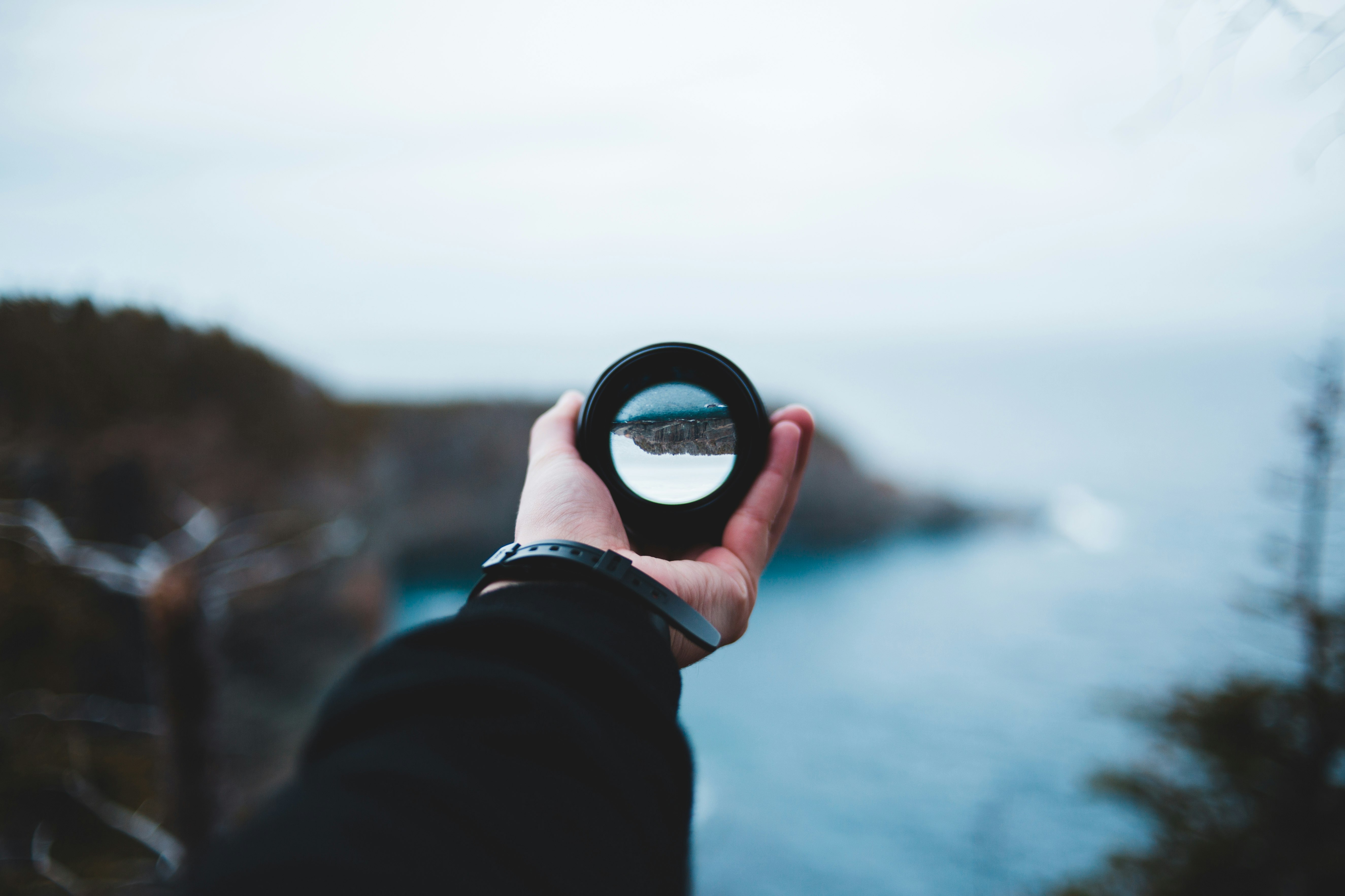 person holding round black and white container